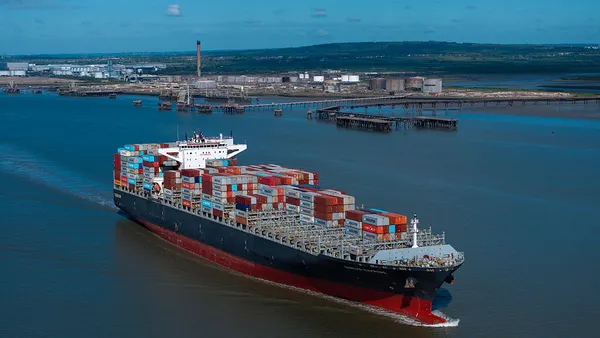 A container vessel traveling trough a waterway.
