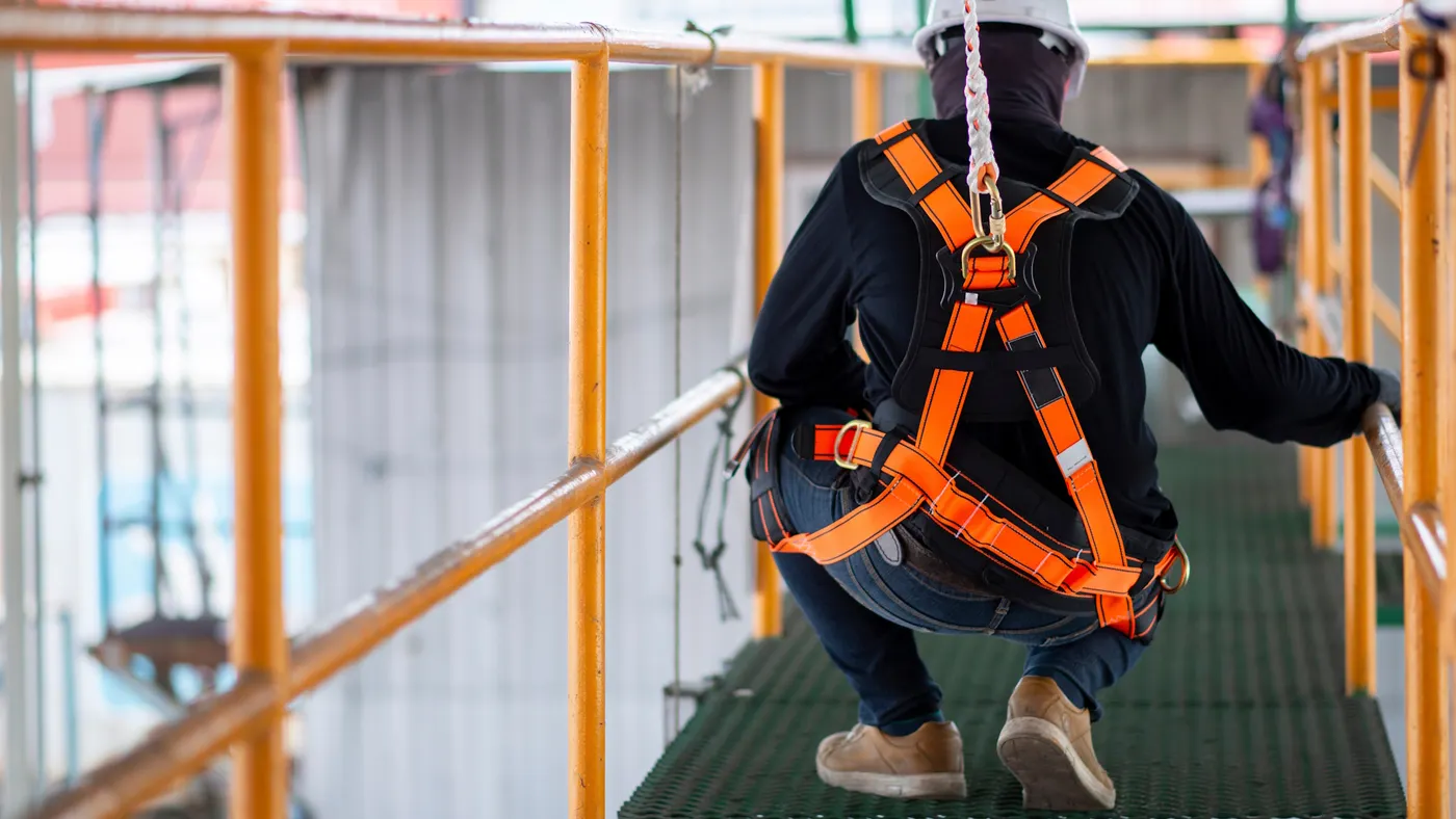 Construction worker on platform wearing vest