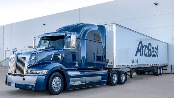 A freight truck outside a warehouse.