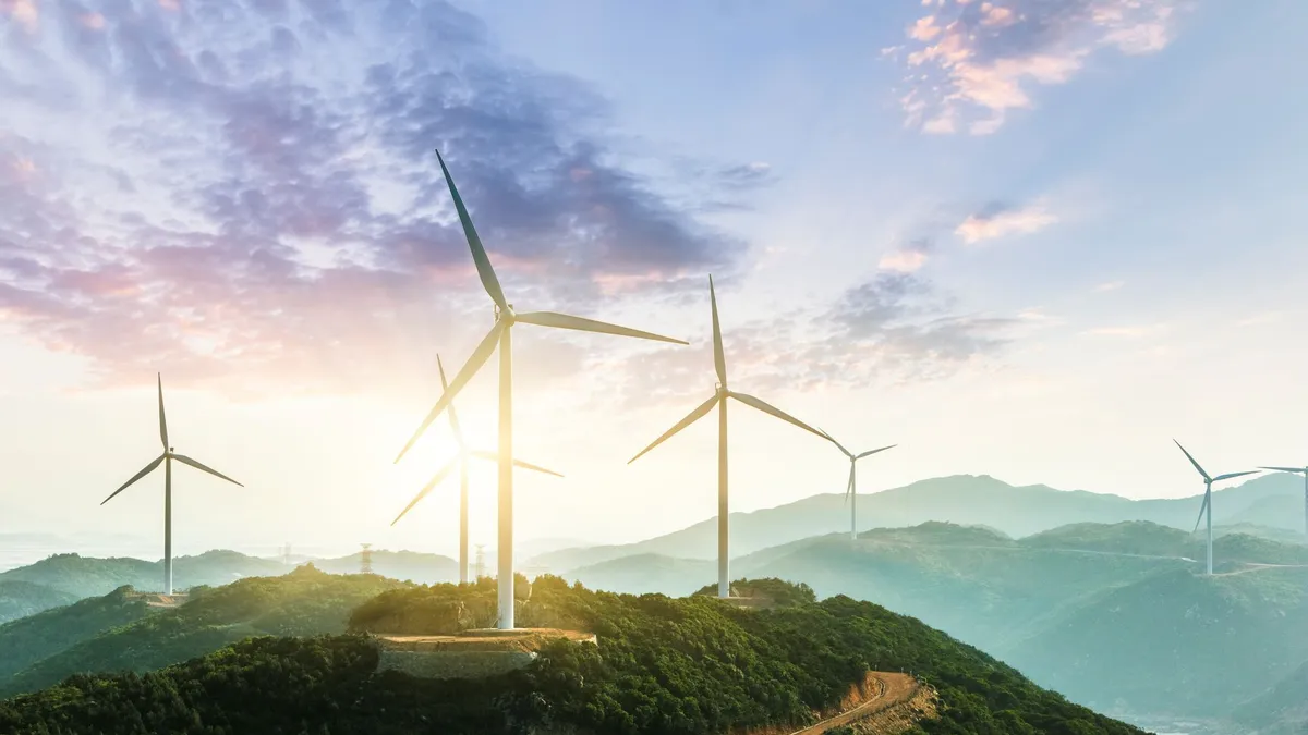 Windmill farm overlooking hills.