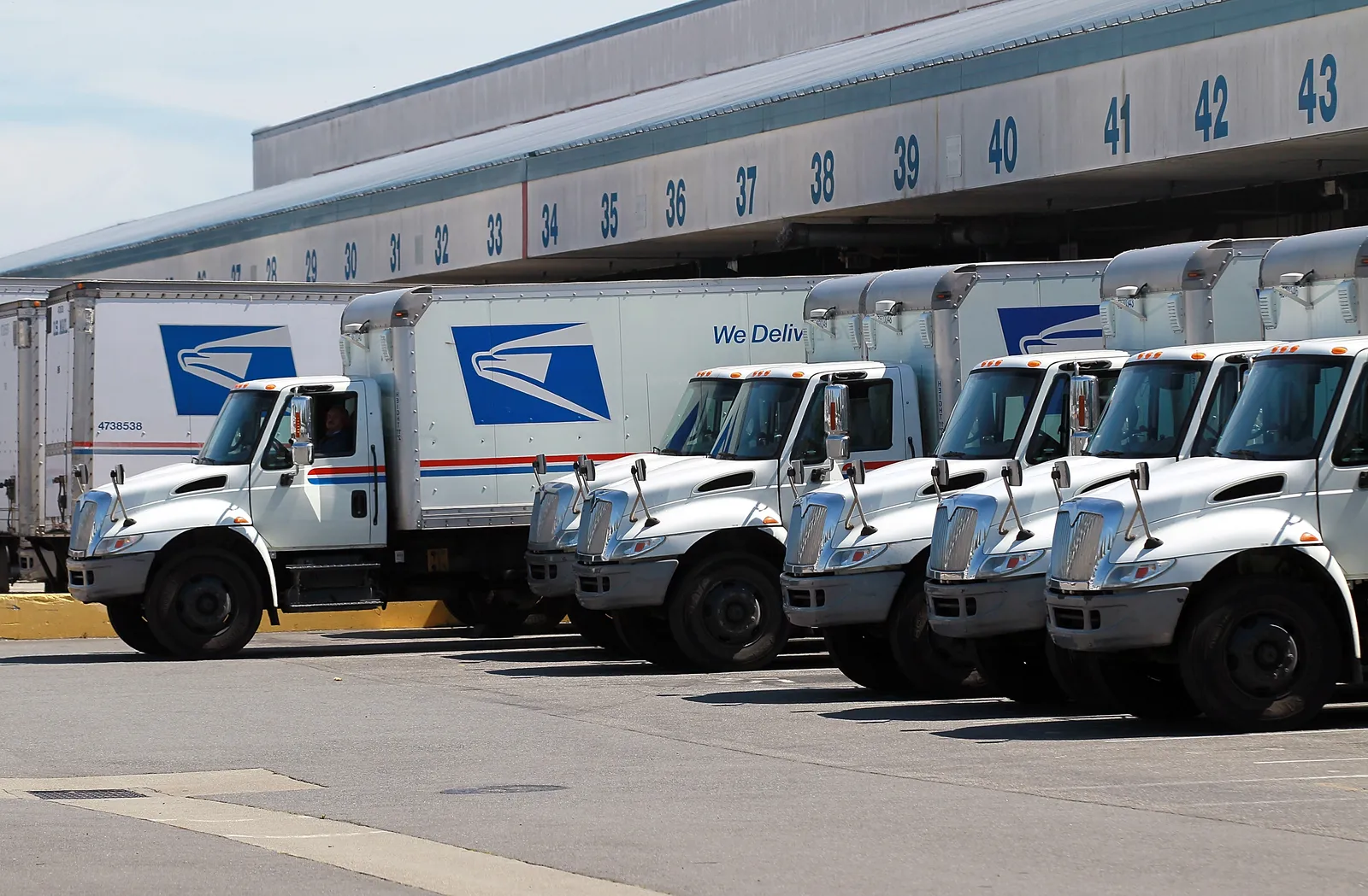 A U.S. Postal Service truck backs into a dock at a facility in San Francisco.