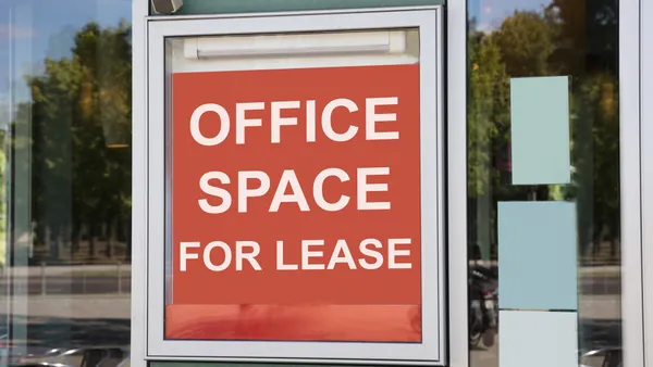 A closeup of a signboard outside a modern office building