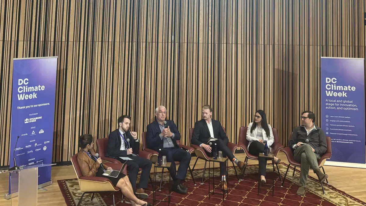 A panel of AI experts gather in an auditorium at Martin Luther King Library in Washington, D.C.