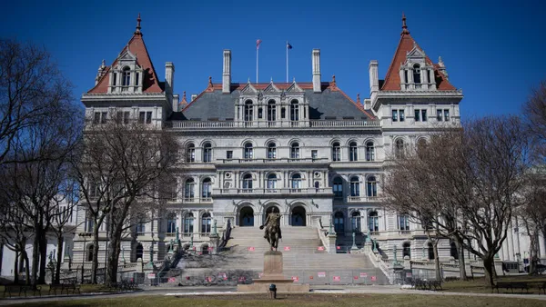 Snow seen melting in front of the New York State Capitol building.