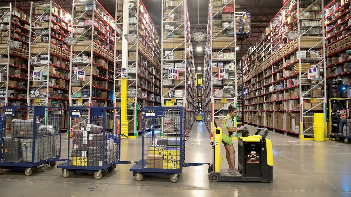 Workers pack and ship customer orders at the 750,000-square-foot Amazon fulfillment center on August 1, 2017 in Romeoville, Illinois.