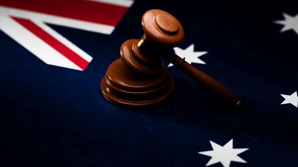 Gavel sitting on top of textured Australian flag