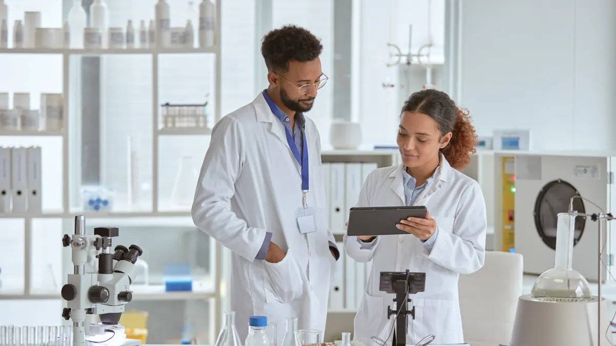 Two young scientists using a digital tablet