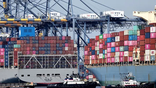 Two ocean vessels docked at an ocean port in California.