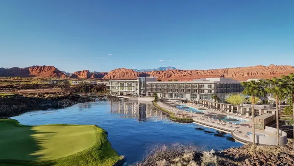 The Black Desert Resort behind a lake in the foreground and mountains in the background.