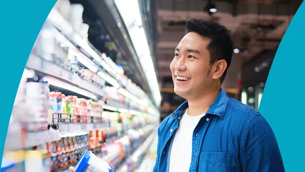 Person in grocery store looking at refrigerated display