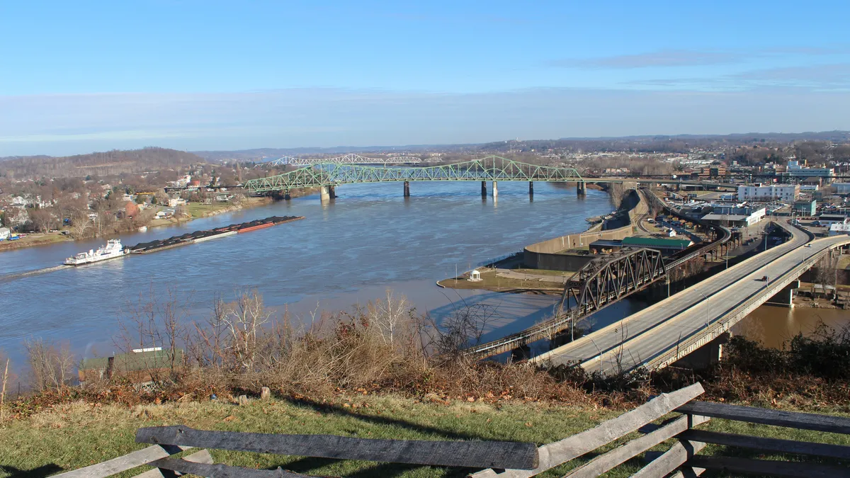 A long distance view of a bridge over a river.