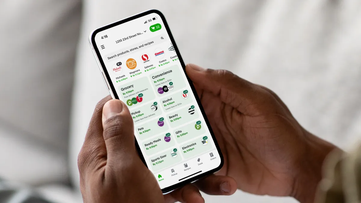 Hand holding a phone with the Instacart App open.