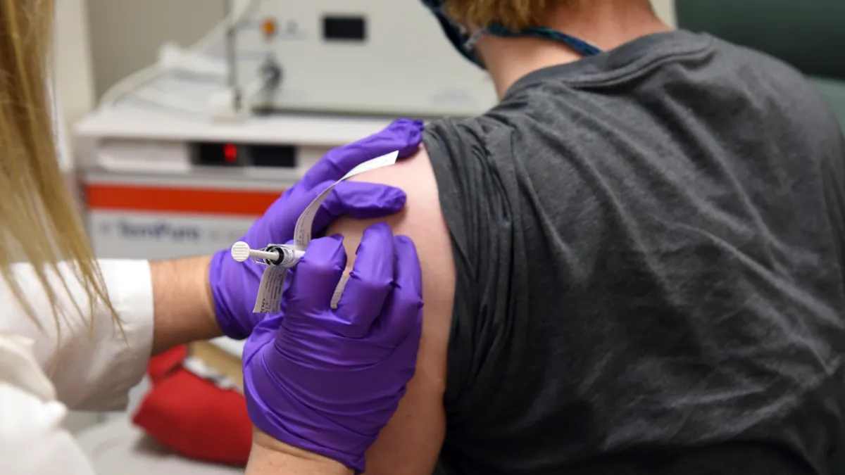 A clinical trial participant is given Pfizer and BioNTech's experimental COVID-19 vaccine at the University of Maryland School of Medicine