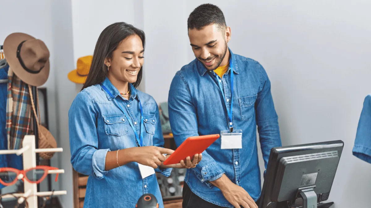 Two employees looking at a tablet together