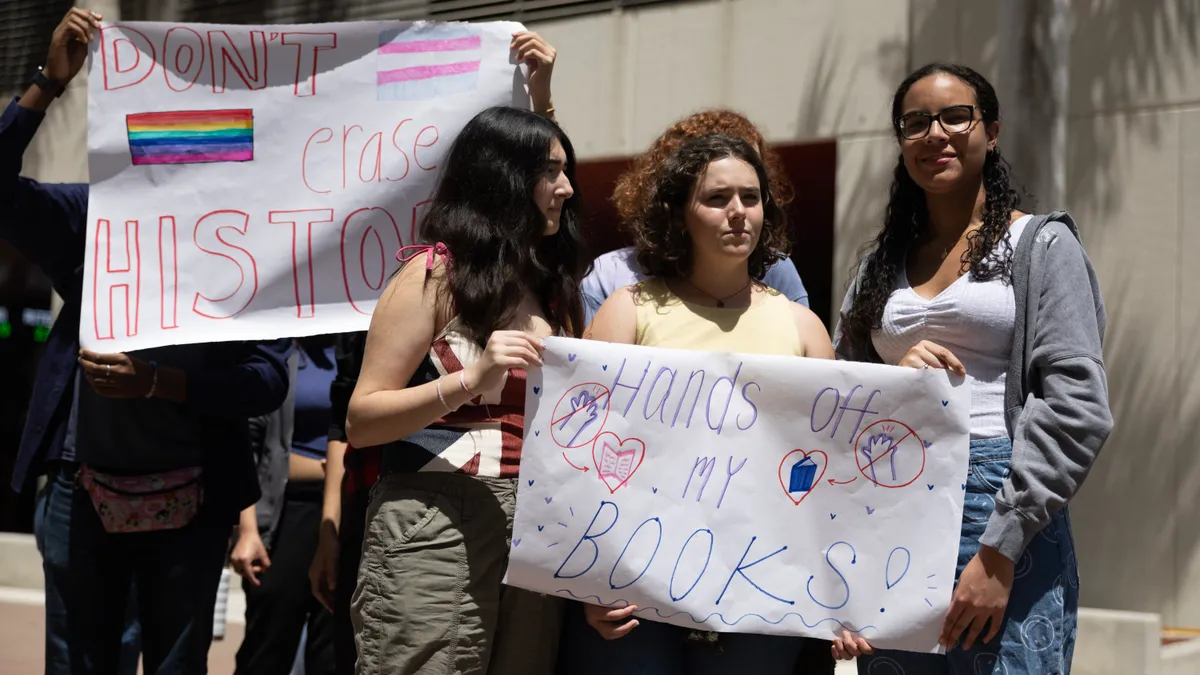 Students hold signs in protest