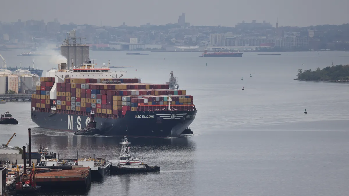 A cargo ship moves towards the Bayonne Bridge as it heads into port on October 13, 2021 in Bayonne, New Jersey.