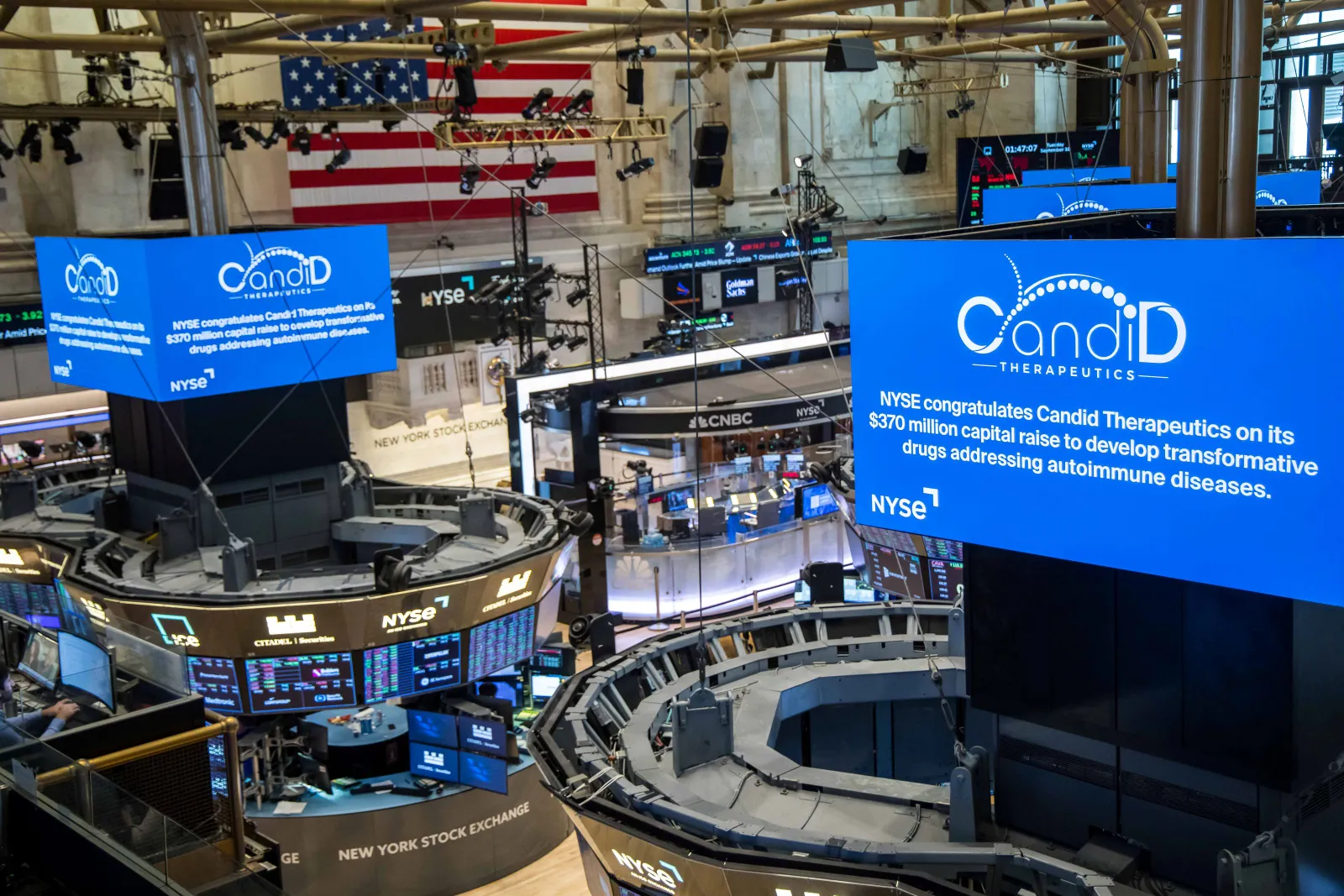 Screens at the New York Stock Exchange congratulate Candid Therapeutics for raising $370 million.
