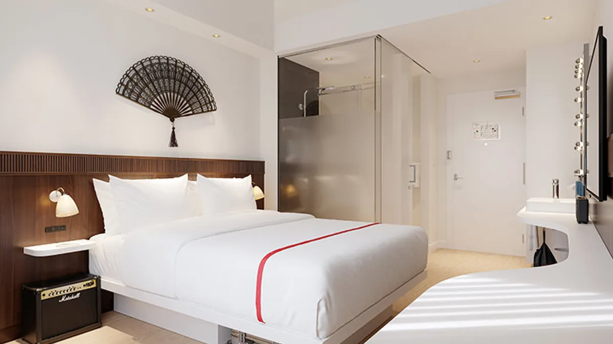 A bed in a hotel room.