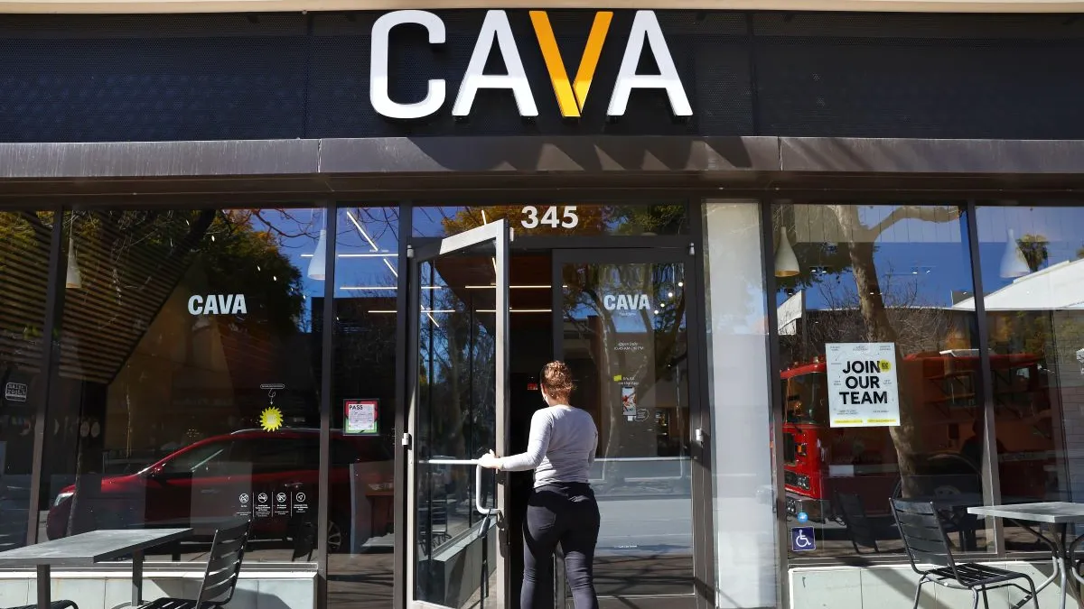 An image of a customer entering a Cava restaurant.