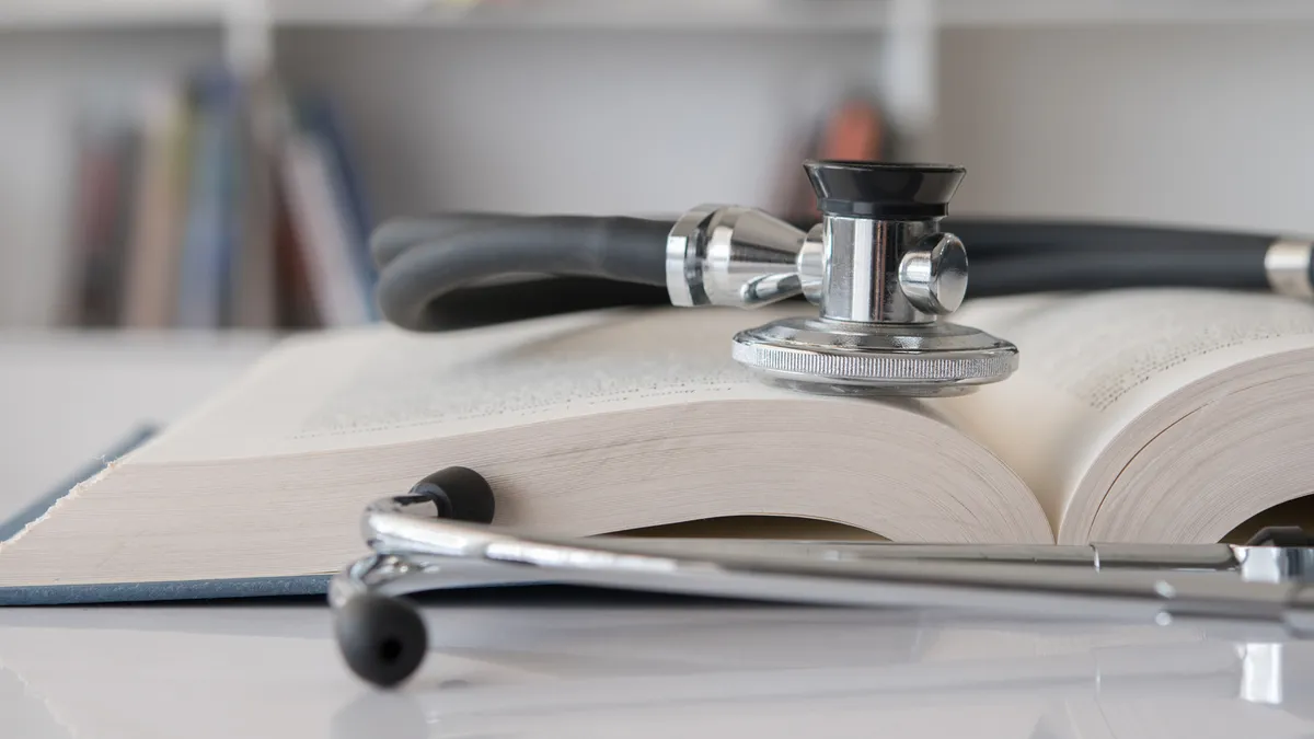 A stethoscope rests on a book.