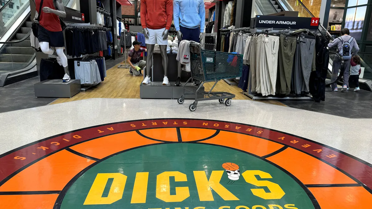 Apparel is displayed inside a Dick's Sporting Goods store.