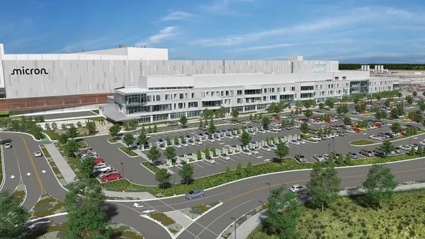 Large conceptual image of building with the Micron logo, parking lot and cars in the front
