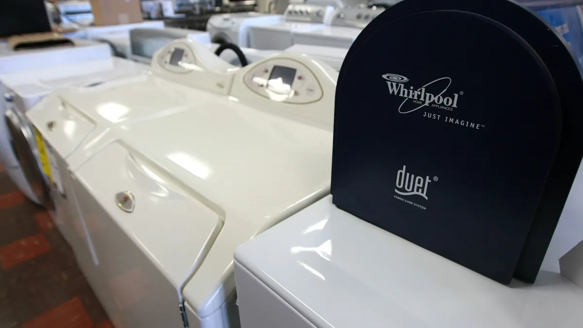 The Whirlpool logo is seen on a display of clothes washers and dryers