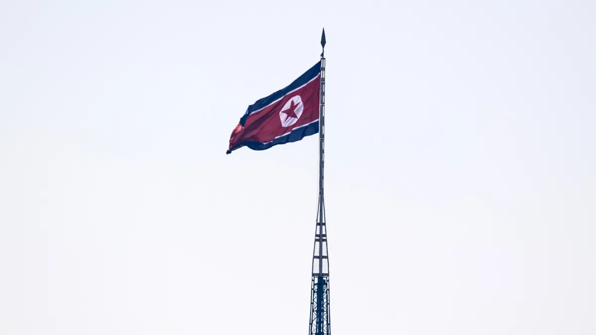 The flag of North Korea flies from a propaganda tower near the Demilitarized Zone with South Korea