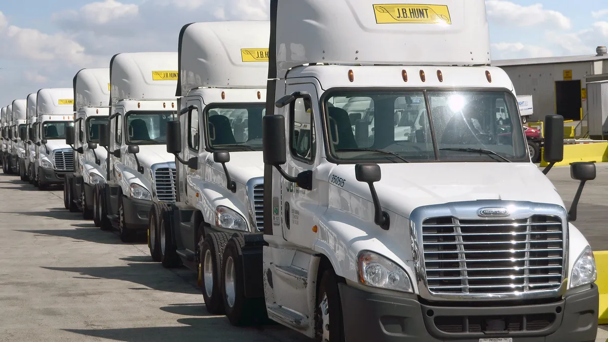 A line of J.B. Hunt tractors.