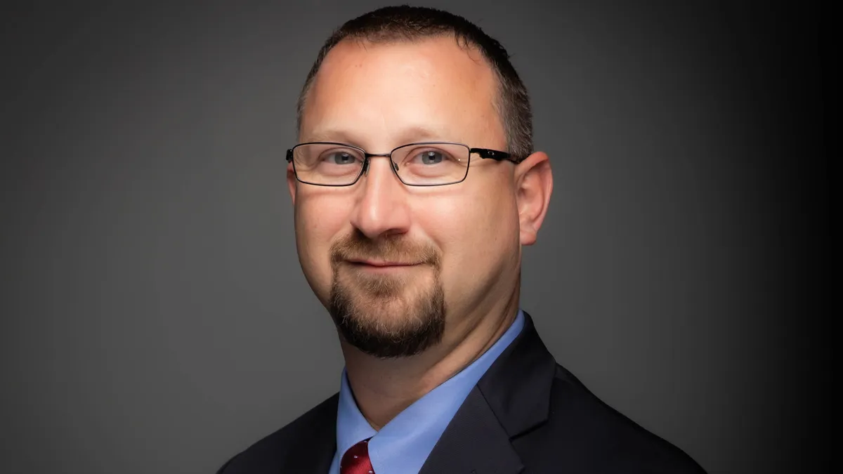 A man wearing glasses in a suit