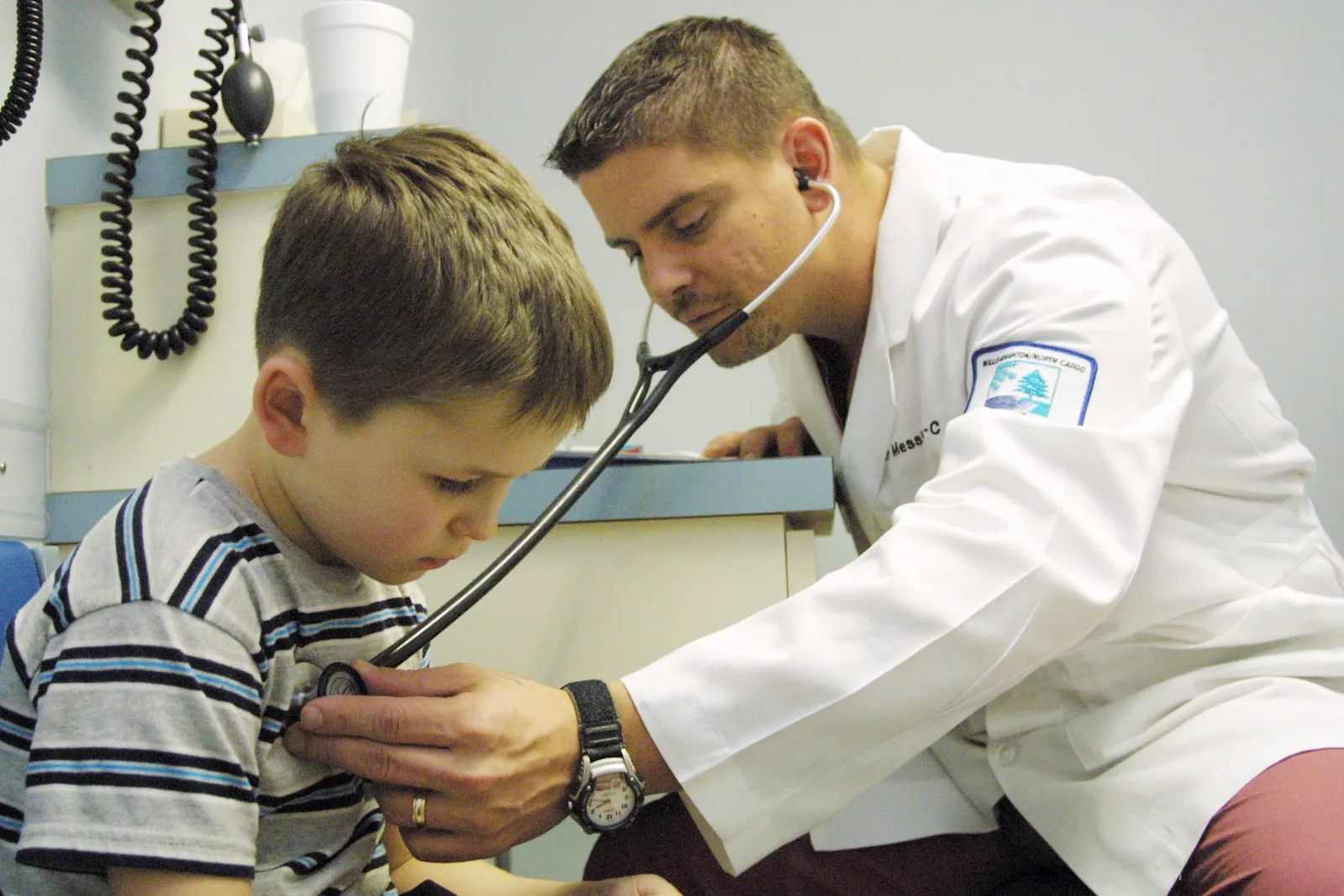 Doctor checks child's chest with stethoscope