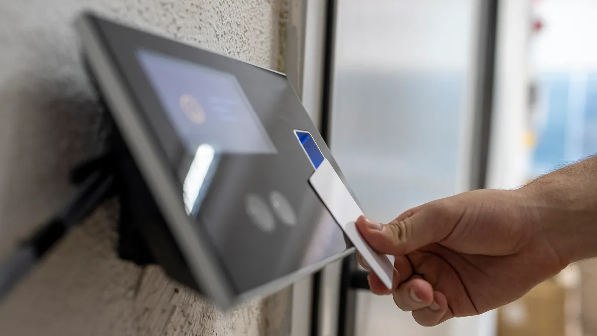 A vendor scans a security card to enter a facility.