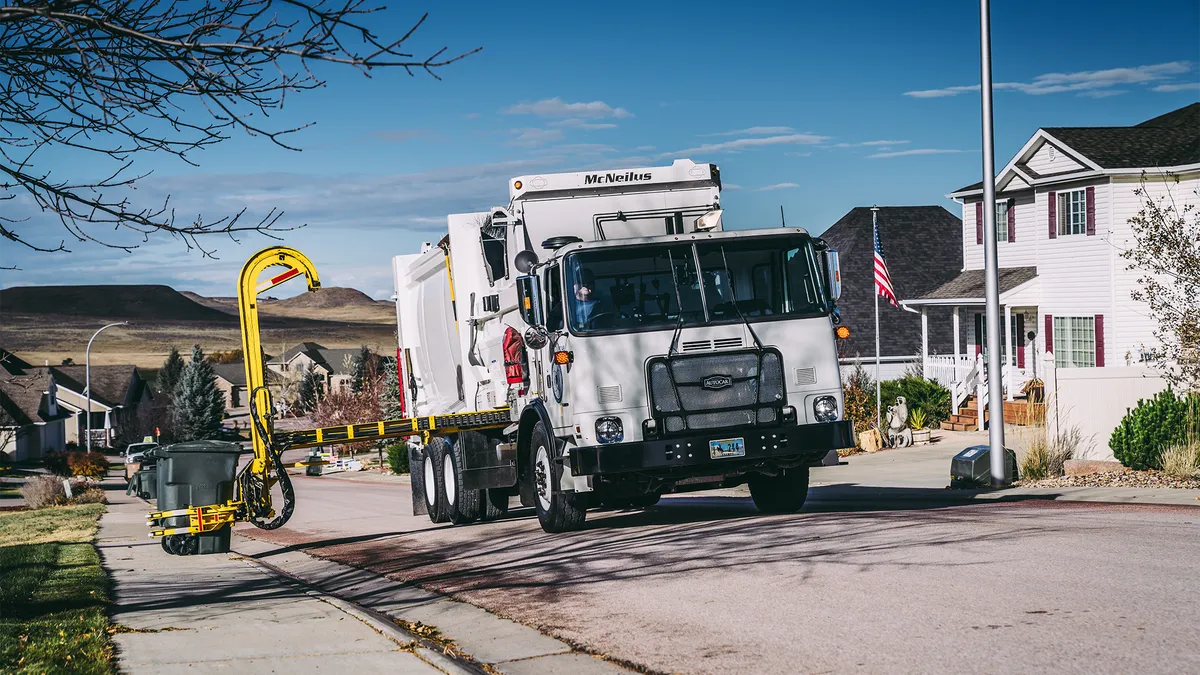 McNeilus Zero Radius Side Loader collecting a cart