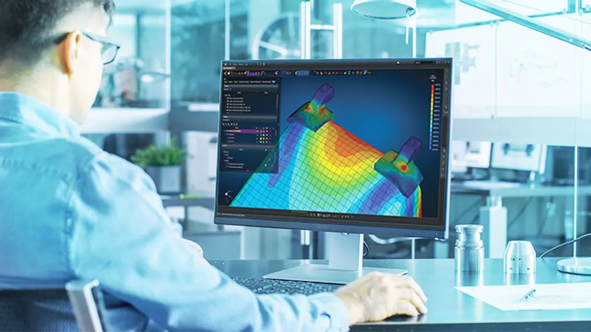 A worker uses Hexagon's design and engieering technology on his computer.