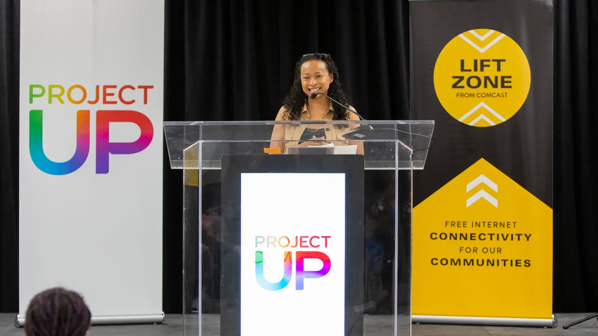 Dalila Wilson-Scott, EVP and CDO for Comcast Corporation and  president of Comcast NBCUniversal Foundation, speaks at a podium