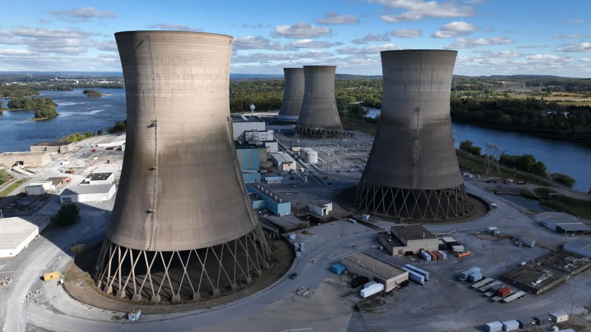 Concrete cooling towers are part of a nuclear power plant.