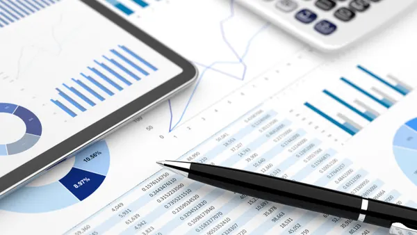 A finacial account report on paper with a pen next to it.