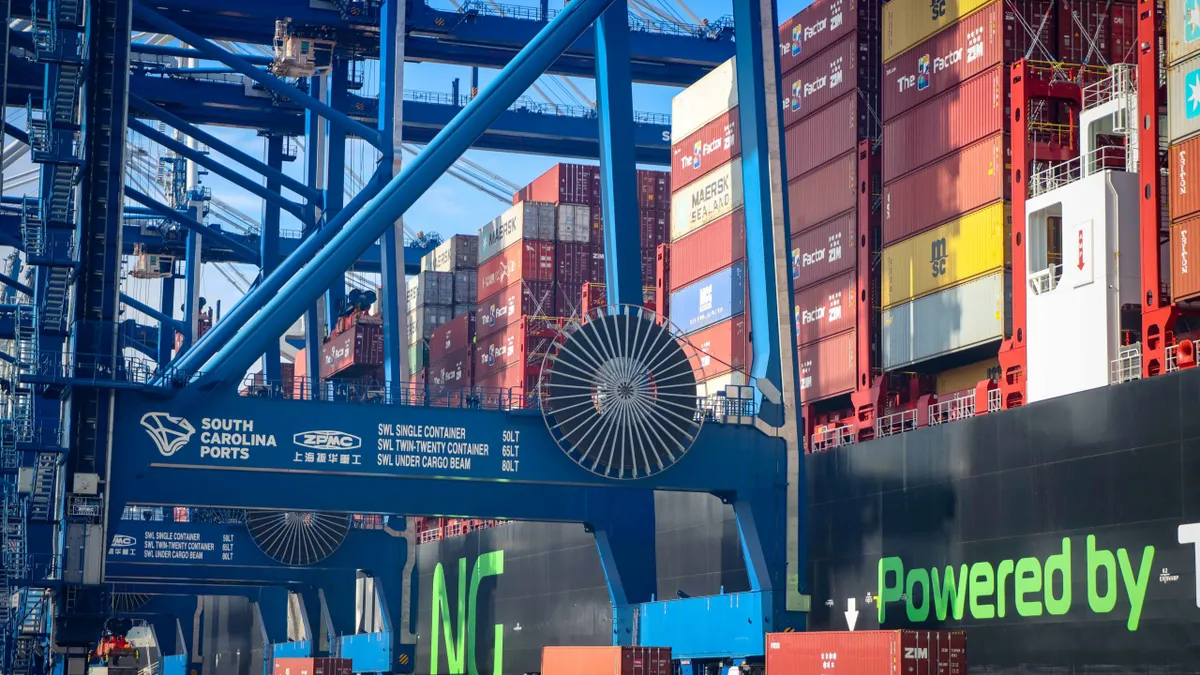 A container ship being unloaded with gantry cranes.