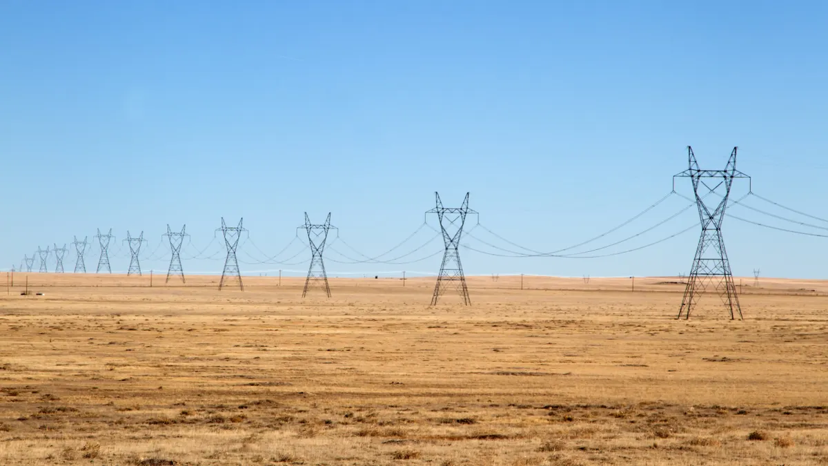 Row of High Voltage Power Lines under a Blue Sky on the plains of eastern Colorado.