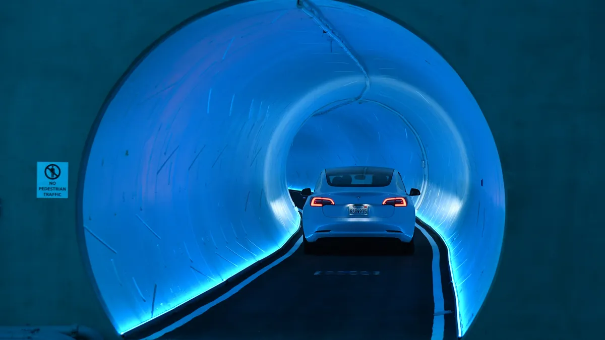 A Tesla car driving in a tunnel during a hyperloop demonstration in Las Vegas.