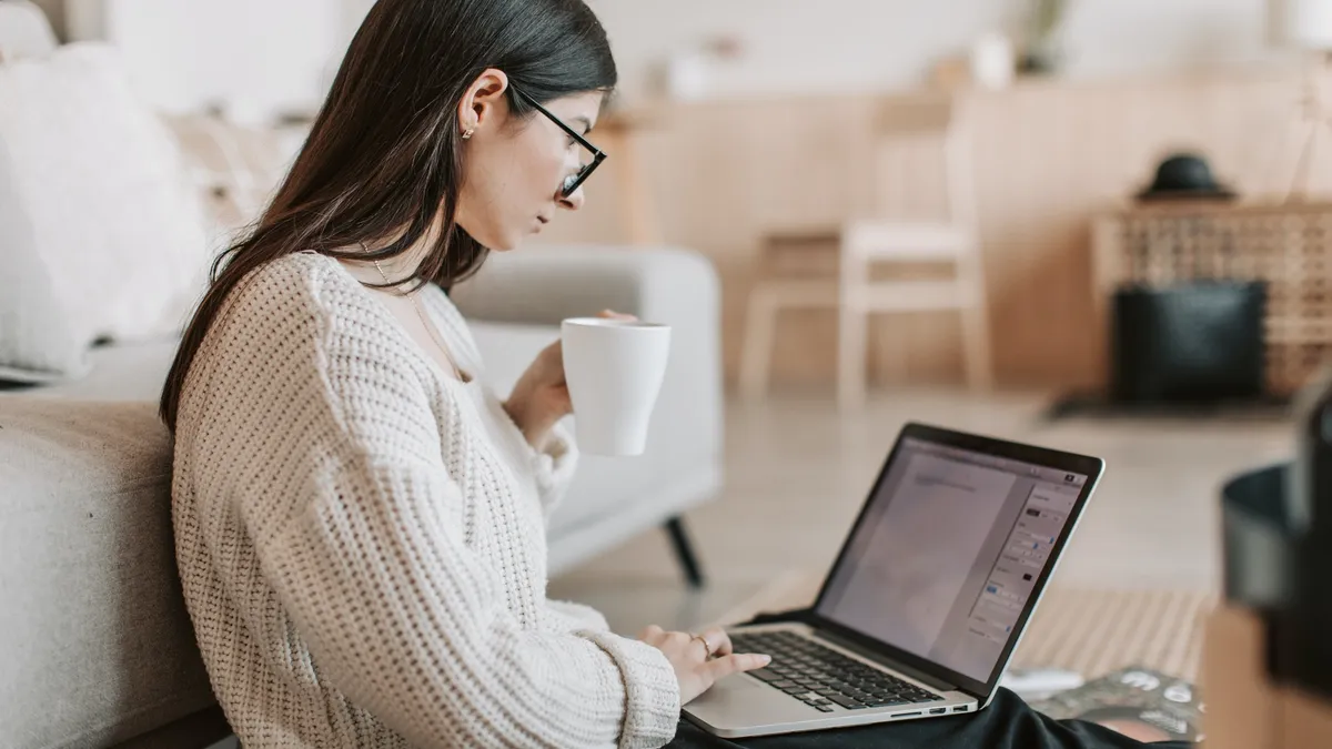 A woman sitting and using a laptop