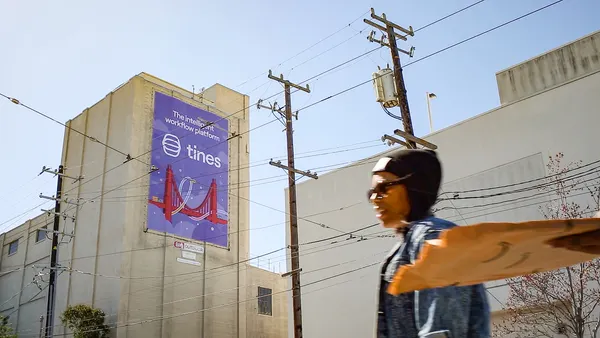 A banner with the corporate logo for tech vendor Tines hangs on a building.