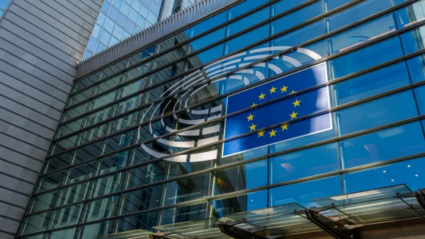 A EU flag on the facade of the EU parliament building.