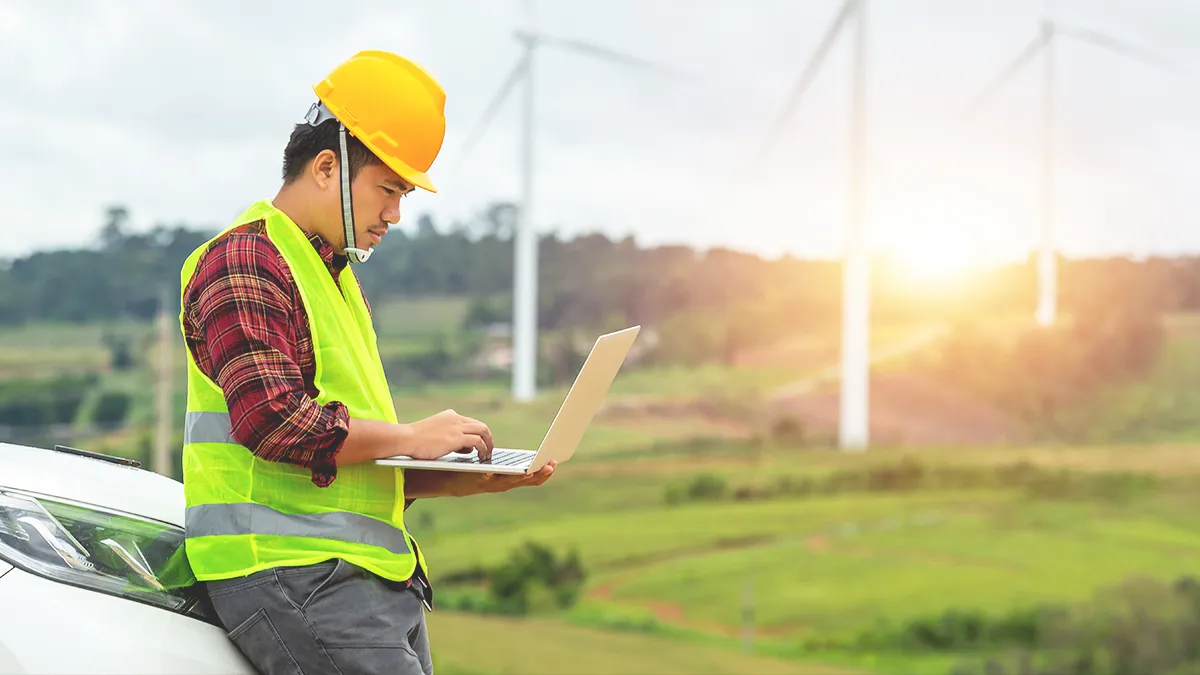 Engineer working in a field with a laptop