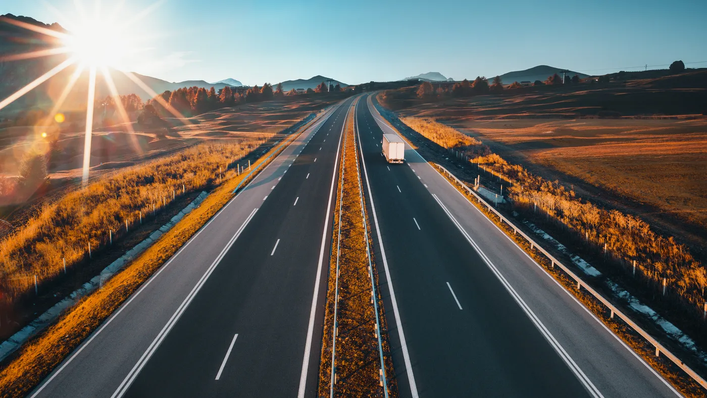 Driving on open road at beautiful sunny day. Aerial view of highway.