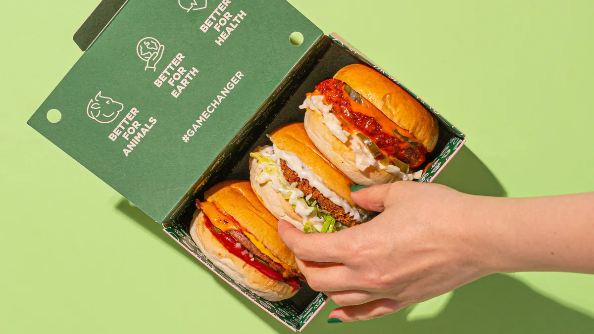 A photo of several Neat Burger sandwiches in a branded box.