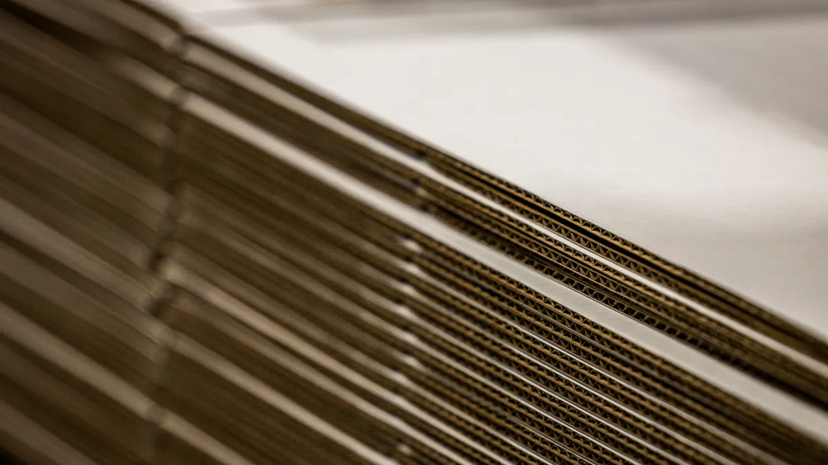 A stack of flattened corrugated boxes.