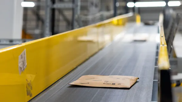 Amazon paper packaging down a conveyor belt.