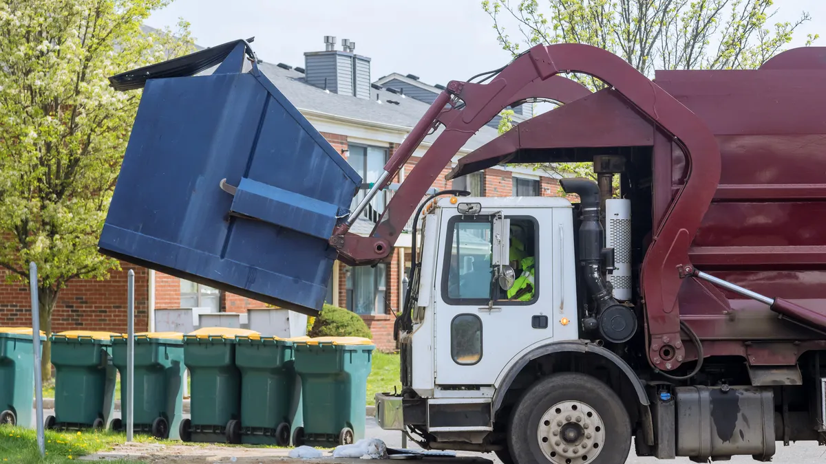 Front load truck collecting a container