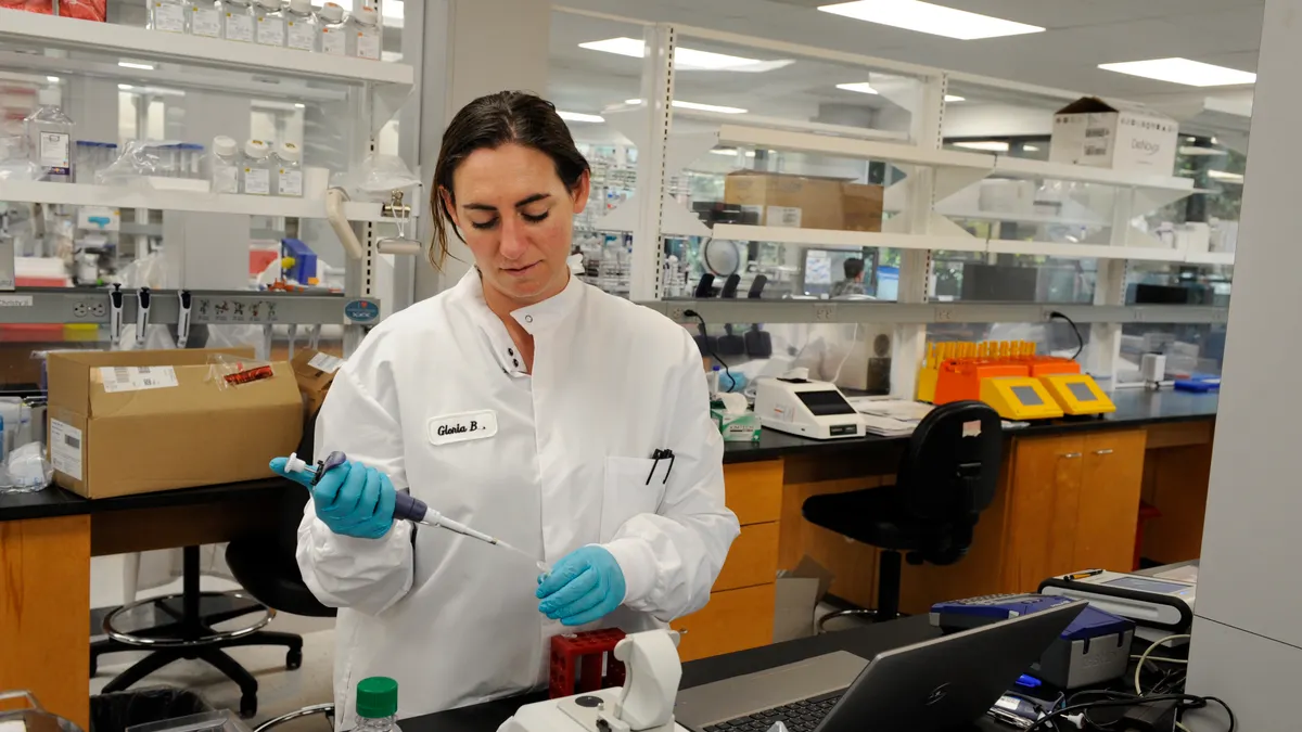 A scientist works in a laboratory at Enlaza Therapeutics.